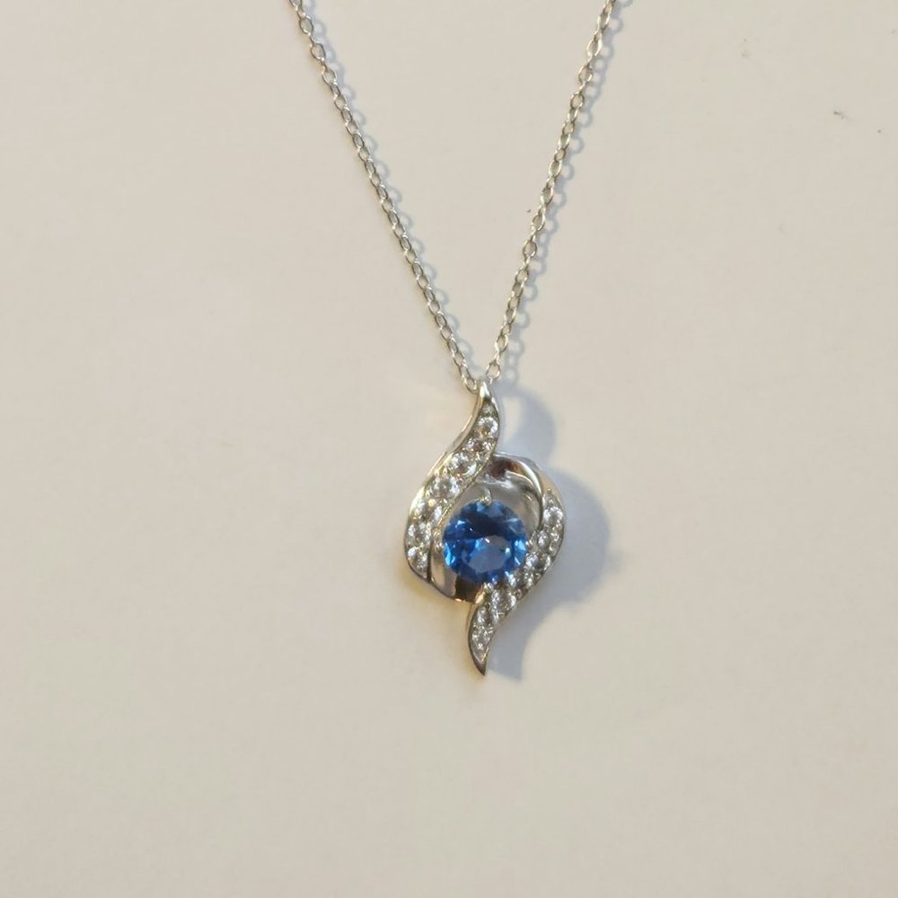 925S Blue topaz, silver necklace, twisted frame with studded cubic zirconia